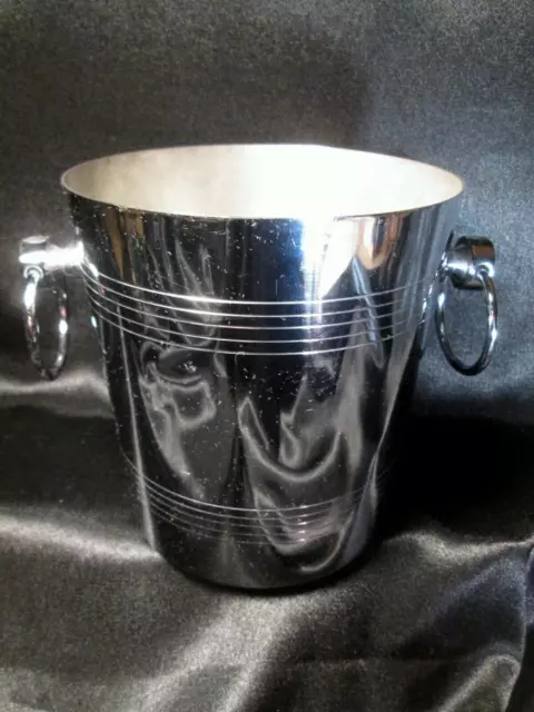 A metal champagne cooler marked Jean Couzon, France