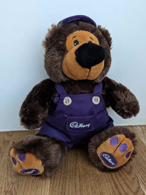 Cadbury World Pre-loved 10" Teddy Bear in Purple Dungarees with Cadbury Logo