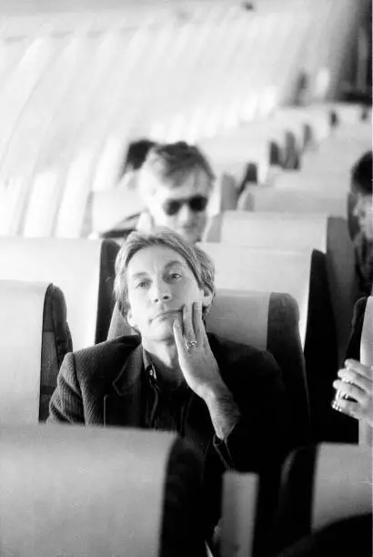 Drummer Charlie Watts of the Rolling Stones sits on a plane during - Old Photo 1