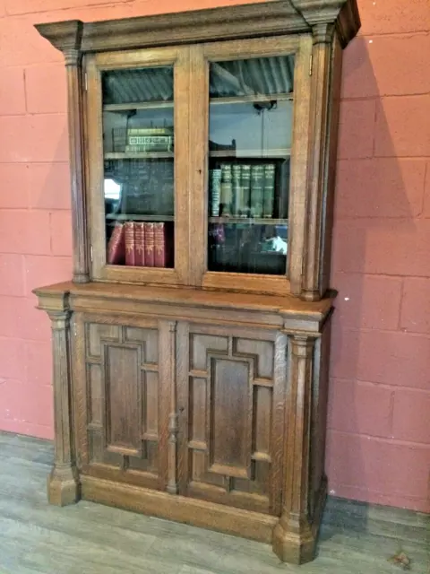 An imposing mid Victorian Gothic style 4 door solid oak book case circa 1860