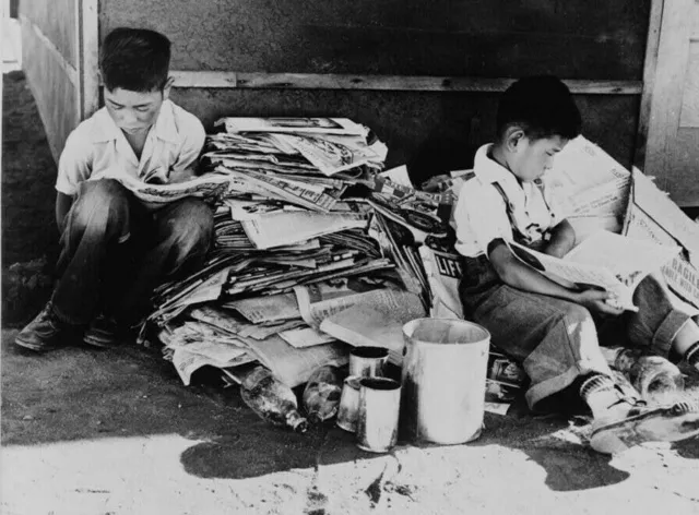 1942 Japanese Boys Looking at newspapers Internment Camps Old Photo 13" x 19"