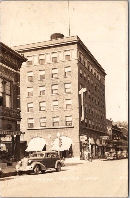 CRESTON, Iowa RPPC Photo Postcard "HOTEL IOWANA" Downtown Street Scene c1940s
