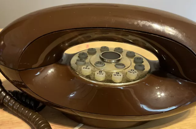 Teléfono retro de colección con botón pulsador Genie Plus con esfera de emergencia.