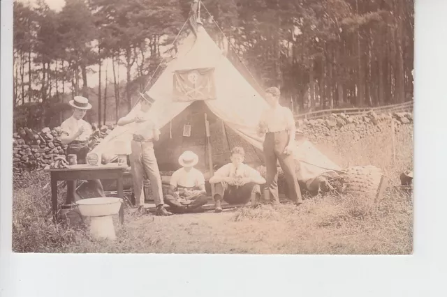 RPPC Young gents camping with Pirate? flag above tent door