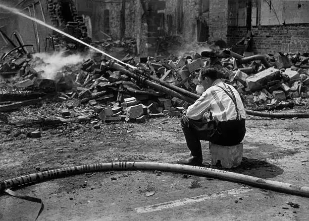 Still wearing pyjamas, fireman drinks early morning cup tea by rui - 1942 Photo