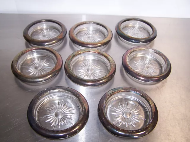 8 vintage glass ashtrays or cup holders. with silver plated rims. made in italy
