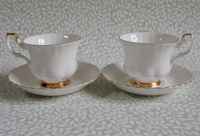 A pair of Royal Albert Val D'Or white & gold tea cups and saucers