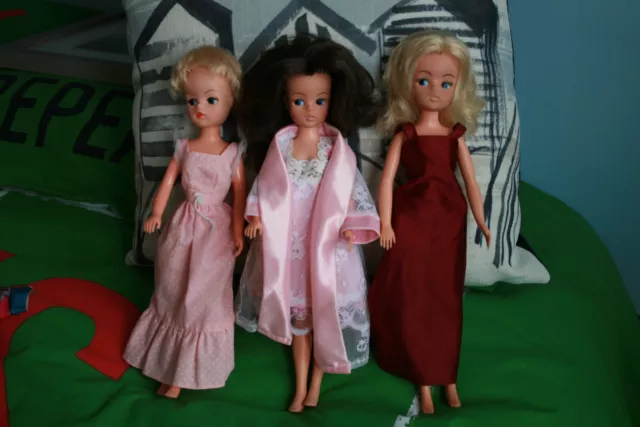 Three Vintage Pedigree Sindy Dolls with clothing includes some Barbie items