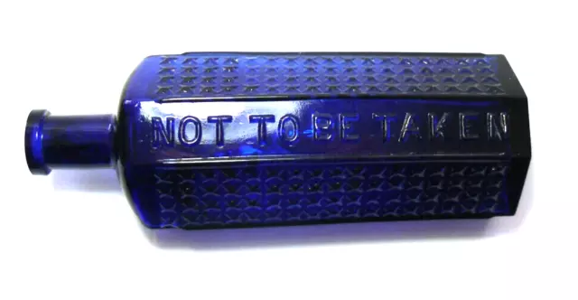 A medium cobalt blue glass coffin shaped poison bottle with Rd number