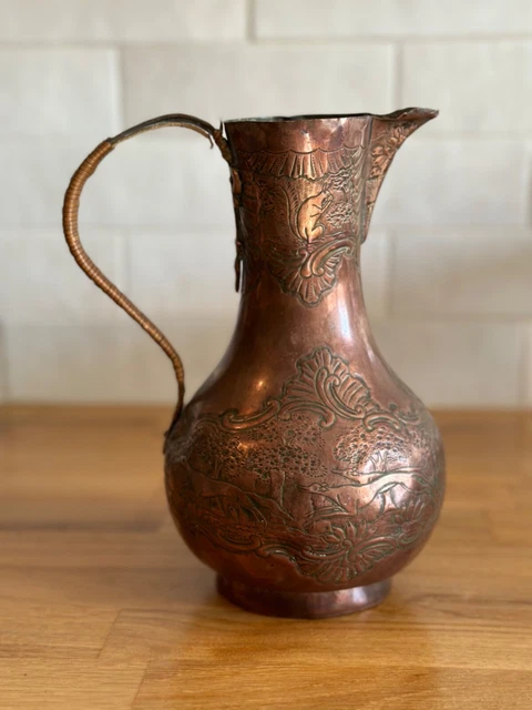 antique carved copper pitcher