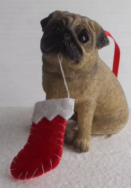 SANDICAST DOG CHRISTMAS ORNAMENT-Fawn Pug Dog Chewing Stocking in mouth