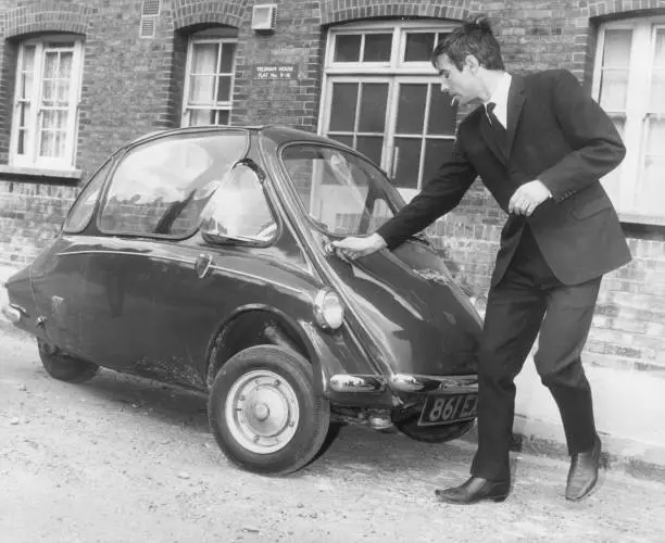 Advertising executive Noel Howard Jones getting into bubble car- 1963 Old Photo