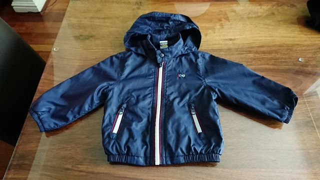 Infant girl deals rain jacket