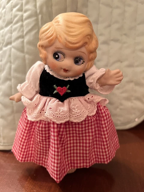Vtg bisque porcelain Kewpie doll Japan with red dress, blond hair, blue eyes