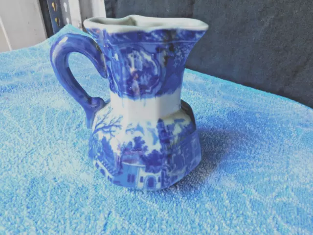 a stunning old style blue and white milk jug