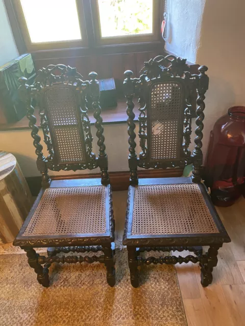 2 GOTHIC THRONE STYLE OAK HALL CHAIRs, LOVELY CARVING. SLIGHT DAMAGE TO ONE ITEM