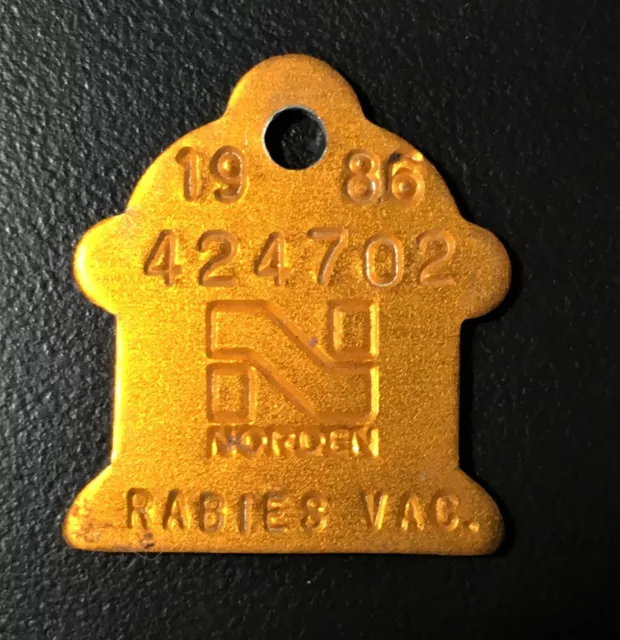 1986 Rabies Tag issued with Company Name of Norden