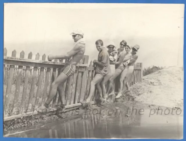Handsome guys and beautiful girls near the fence Vintage photo