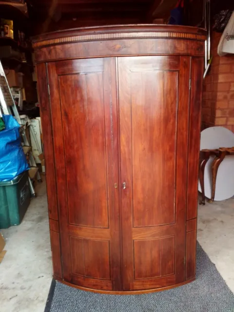 Antique mahogany bow corner cupboard