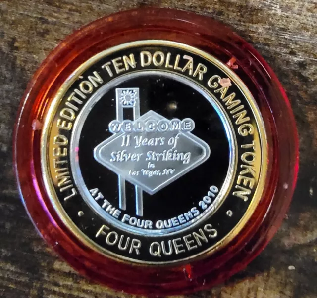 2010 FOUR QUEENS $10 RED Cap .999 Silver Strike 11 Years of Silver Striking Sign