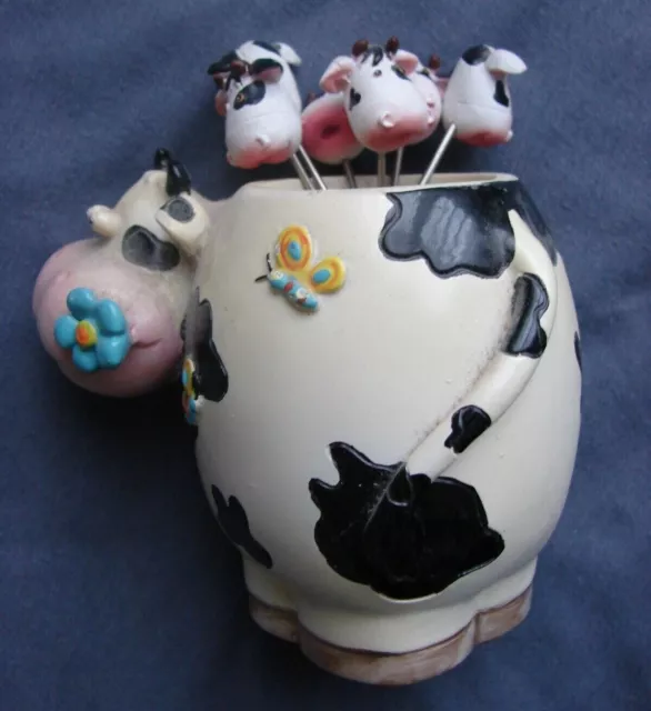 Figurine d'une vache en porcelaine "PORTE 6 vaches PIQUES pour BULOTS"