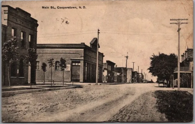 1912 Cooperstown, North Dakota Postcard MAIN STREET Downtown Scene / Bloom Bros.