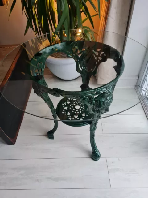 Cast Iron table with round glass top.