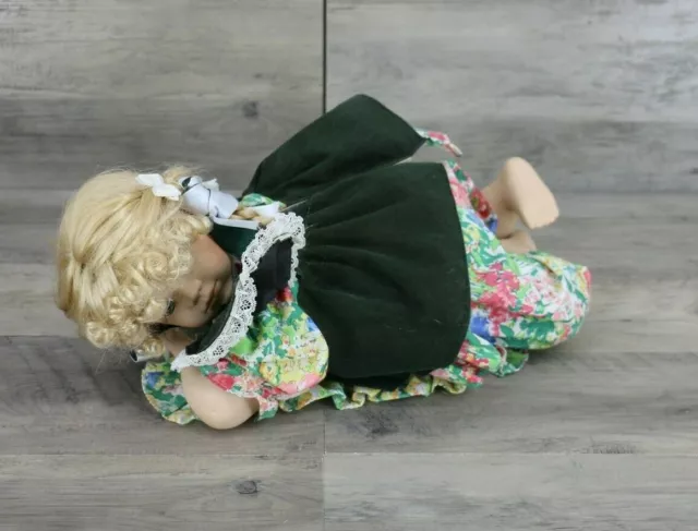 Heritage Signature Collection Porcelain Doll On Belly with Rug in Floral Dress