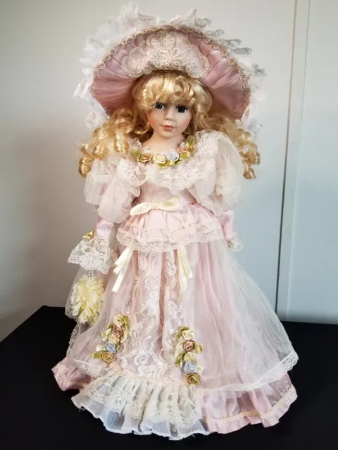 Heritage doll 16  blonde hair w/blue eyes has  music box that works. W/ stand