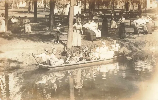 1910s Camping family In Canoe Real Photo Postcard RPPC outdoors boat house Rare