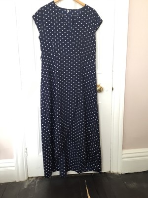 dress polka-dot white spots on navy background, faux wrap with tie belt.