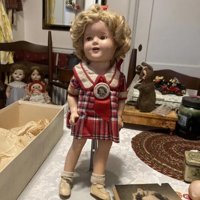 Antique Shirley Temple Doll. Composition Doll With Original Clothes, Badge Tag.