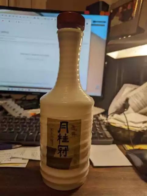 white ringed bottle with cork, (possibly saki bottle?) great condition 10" tall,