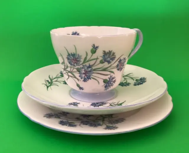 SHELLEY “CORNFLOWER”  FOOTED TEA CUP, SAUCER& PLATE TRIO SET. Blue /White