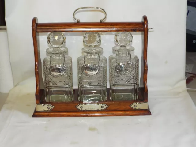 Lovely Edwardian lockable Tantalus with 3 decanters & silver labels