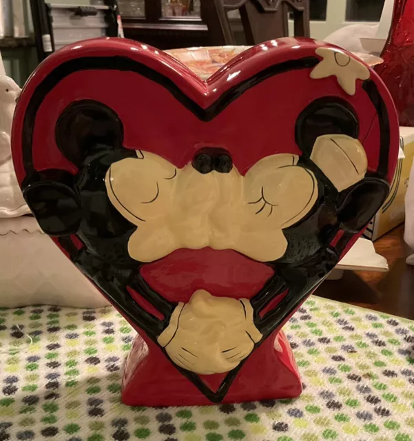 Mickey and Minnie kissing.  Red, heart-shaped bank.