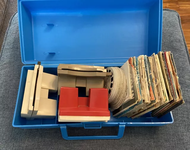 Lot of three View-Master viewers, lots of reels, and 1970s blue plastic carrying
