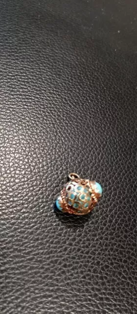 10K Yellow Gold Charm with Intricate Basket Mounting Design and Blue Glass Bead