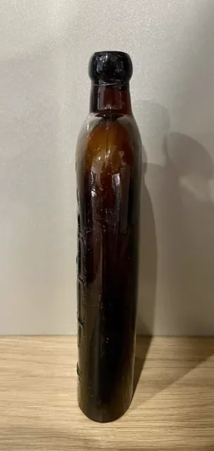 Warners Safe Cure Melbourne Amber Glass Blob Too Embossed Pictorial Bottle 2