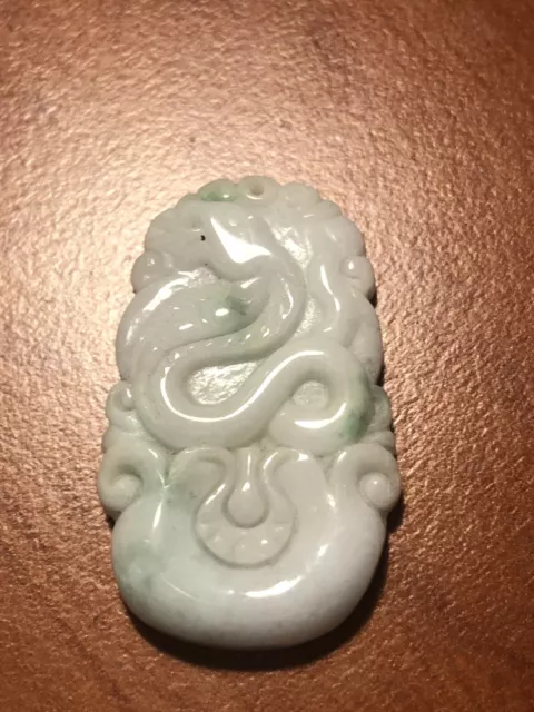 Fine Chinese Carved Oval Circular Jadeite Pendant Of Snake Form.