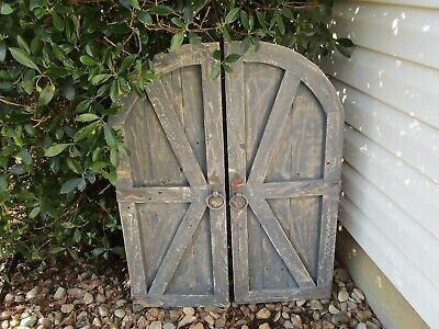 Pair of distressed gray vintage inspired round top barn doors with hardware