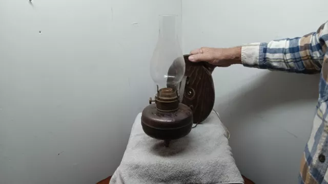 Old kerosene wall light has been electrified. brass.