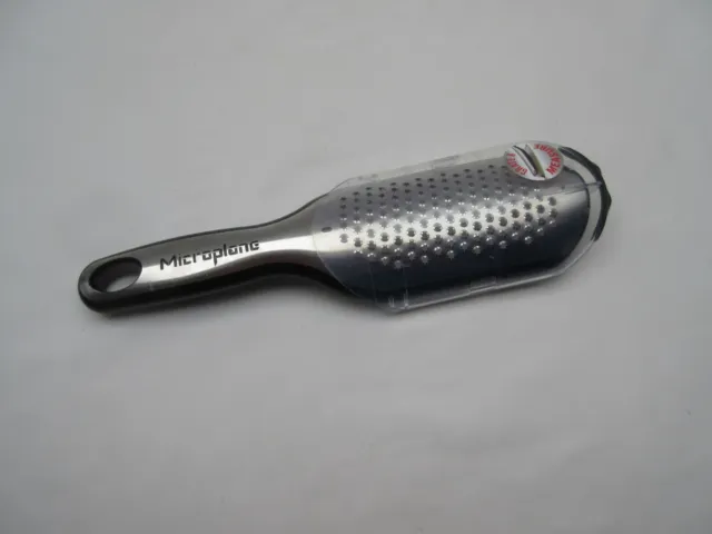 Microplane nutmeg grater with measure collection sleeve