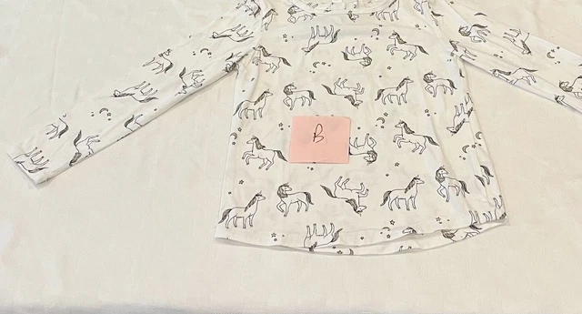 Carters size 6/6x long sleeve white top with black and gold unicorns