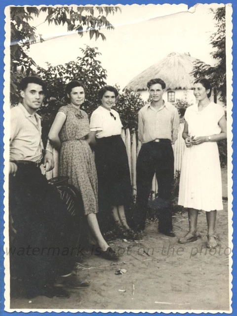 Beautiful girls and a guys near a village house 1957 Vintage photo