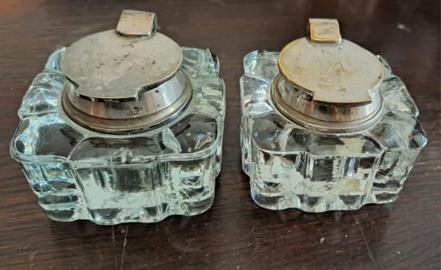 Pair of vintage glass inkwells with silver plated lids.