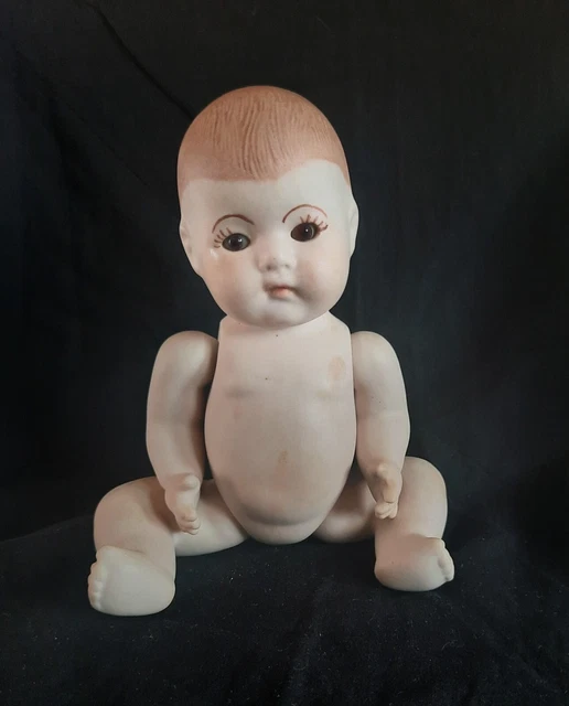 Vintage dionne 8" porcelain baby Doll.