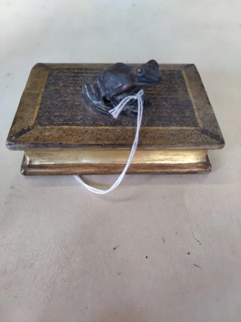 Small Bronze Frog On A Small Book