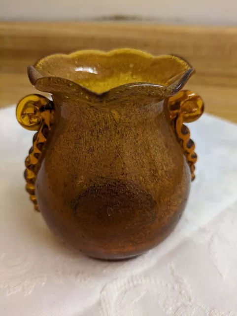 Vtg. hand made glass vase; amber. Scalloped with applied handles.
