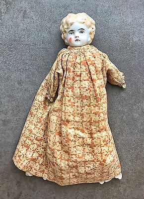 An Antique Porcelain Head Doll